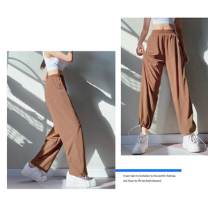 Detail view of high waist loose brown joggers featuring adjustable drawstring ankle cuffs