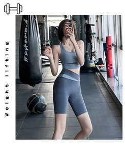 Detail view of high-waist yoga shorts with cross-color拼接 design and elastic sports fabric