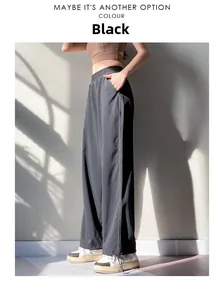 Detail of high waisted black joggers featuring side decorative stitching and breathable fabric