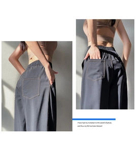 Detail of high-waist charcoal grey athletic pants with elastic waistband and back pockets