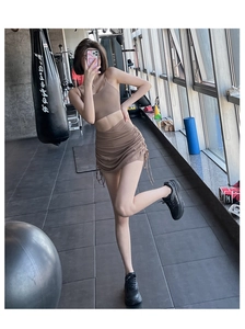 Detail of high-waist fitness skirt shorts with side drawstring in coffee brown color