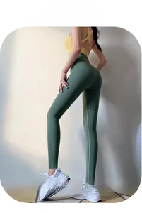 Close-up of high-waist dark green yoga leggings featuring breathable laser-cut mesh details