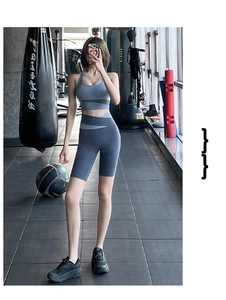 Detail of high-waist grey-blue yoga shorts and sports bra with contrast stitching
