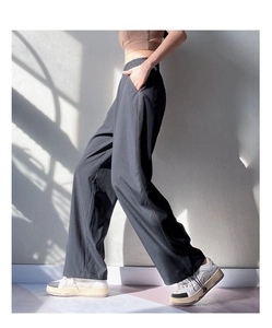 Detail view of high waist loose joggers with elastic waistband and contrast stitching