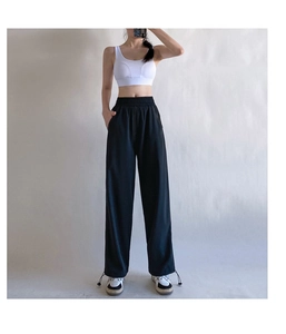 Detail of high waist elastic waistband and drawstring hem on black quick-dry sports pants