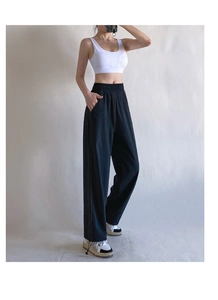 Full body shot of loose high-waist yoga pants with adjustable drawstring cuffs in black