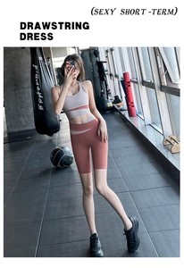 Detail showing two-tone high waist athletic shorts and halter yoga top in gym setting