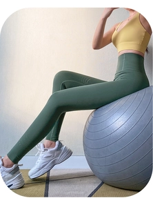 Close-up of high-waist breathable mesh yoga leggings in dark green showing seamless knit detail