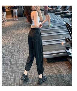 Detail view of high waisted joggers featuring reinforced back pockets and drawstring waist