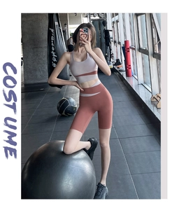 Close-up of high-waist fitness set in grey-purple and brick red color block design