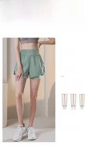 Detail of high waisted light green sports shorts with built-in liner and ruffled waistband