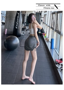 Close-up of adjustable drawstring and side ruched detail on dark grey athletic shorts