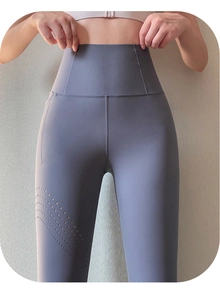 Detail of high waist yoga pants featuring laser-cut breathable holes and curved stitching