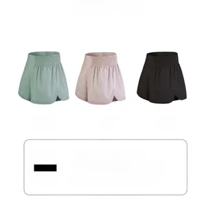 Detail view of high-waist 2-in-1 sports shorts in green, pink, and black colors