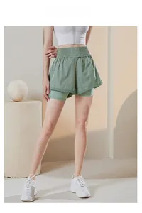 Detail of high-waisted 2-in-1 sports shorts showing wide elastic waistband and inner lining