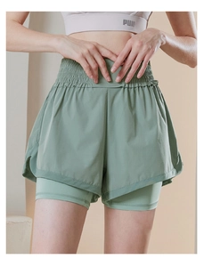 Detail view of the layered high-waisted shorts with inner compression lining in sage green