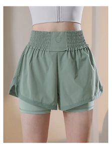 Detail view of high waisted two-in-one sports shorts with elastic shirred waistband