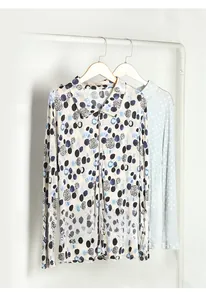 Detail of silk printed long sleeve shirts featuring classic collars and artful dot patterns