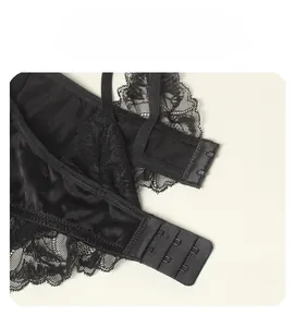 Detail of the three-row hook and eye closure on black silk lace bra for women