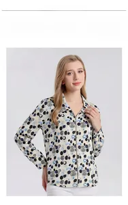 Detail of silk printed long sleeve shirt with zipper and blue geometric polka dots