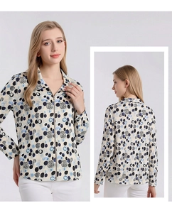 Detail view of silk printed blouse with zipper closure and geometric patterns