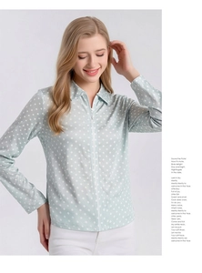 Detailed view of women's mint green silk shirt featuring white polka dots and zipper front