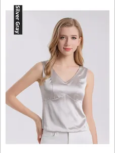 Detail of silver grey silk V-neck tank top with smooth satin texture and elegant sheen