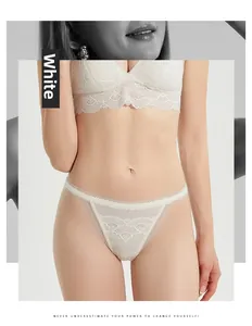 Close-up detail of white silk lace lingerie set with floral embroidery on soft fabric