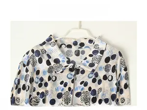 Detail of silk printed shirt showing classic collar and smooth zipper closure