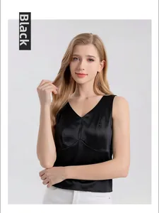 Detail of a black silk tank top with a deep V-neck and premium satin texture