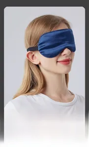 Adjustable dark blue silk sleep mask on model showing elastic strap and smooth texture