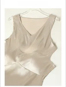 Detail of champagne silk V-neck tank top featuring smooth texture and premium finish