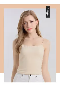 Detailed view of nude silk camisole with thin straps and a slim fit on model