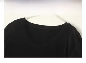Close-up detail of smooth V-neckline and silk knit fabric texture on black t-shirt