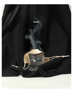 Breathable beige silk nose mask shown over a steaming glass to demonstrate airflow