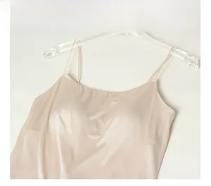 Detail of silk camisole in light champagne with slim straps and built-in padded cups