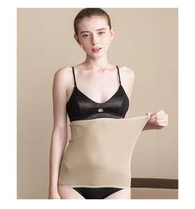 Detailed view of high-stretch skin-tone wool waist warmer with seamless ribbed knit texture