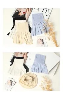 Detailed close-up of 100% silk neck gaiters with pleated texture and wavy hem decoration