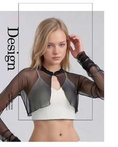 Detail of sheer black silk mesh shrug featuring long sleeves and ruffled edge design