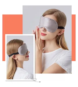 Detailed macro view of silver silk sleep mask with adjustable strap for total blackout