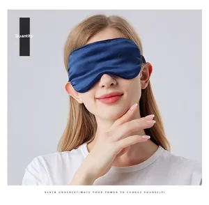 Detail of navy blue mulberry silk sleep mask with elastic strap on a female model
