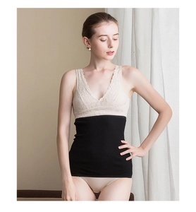 Close-up of black seamless 100% fine wool waist warmer with ribbed texture on model