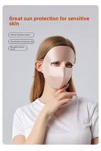 Detail of silk full face sun protection mask with adjustable ear loops in champagne gold
