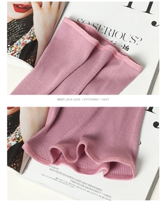 Close-up of pink wool thermal vest with silk lace neckline and lettuce edge details