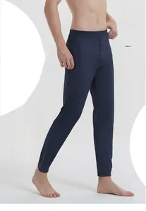 Detail of navy blue men silk thermal pants with elastic waistband and button fly closure