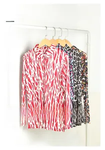 Detailed close-up of premium silk long-sleeve shirts with assorted vibrant print patterns