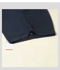 Detail view of men's silk thermal pants featuring a wide ribbed elastic waistband and button