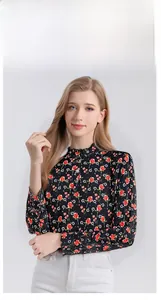 Detailed view of women's silk blouse featuring floral print and ruffled stand collar design