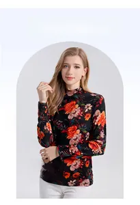 Detail of high-neck wool sweater with vibrant vintage floral print in orange and purple