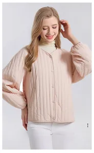 Detailed view of pink quilted jacket cuffs and 100% mulberry silk filling texture